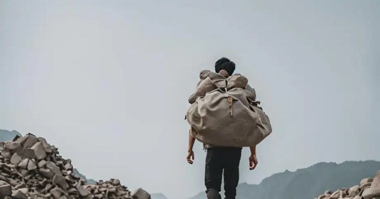 A man carrying a bag of rocks